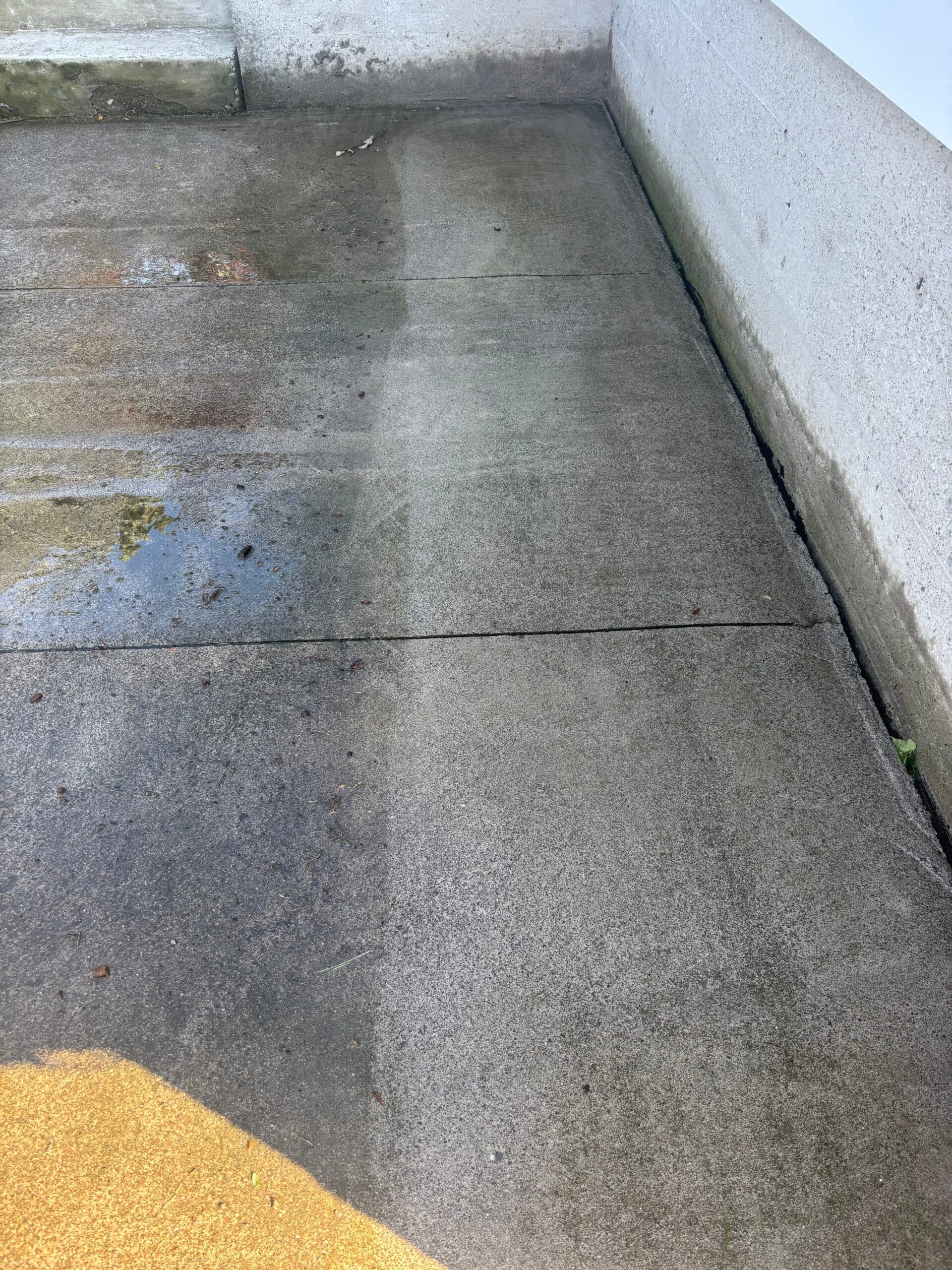 Before and after pressure washing — concrete surface